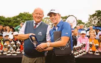 Zoe presents Bob Gunning Manager of Longniddry Golf Club with a US Kids plaque